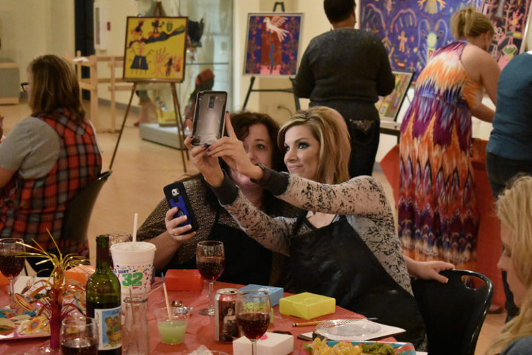 Two women posing for a quick selfie at event sponsored by Corporate Partner, Girls Gone Wine