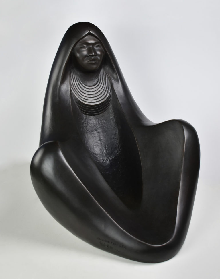 A rounded, abrascted women covered in a blanket (by Allan Houser)