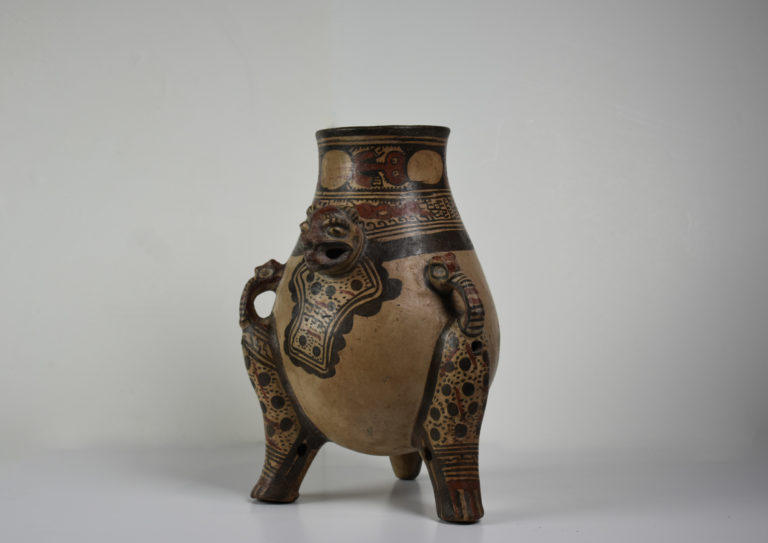 A ceramic vessel with the head of an ocelot molded onto it